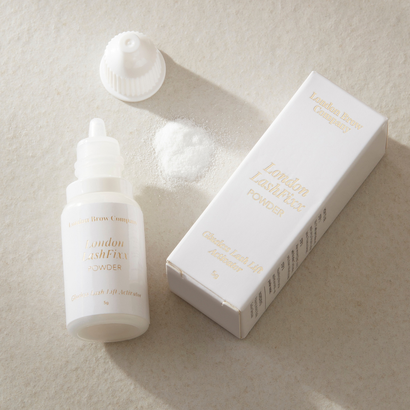 White skincare product bottle and packaging on a beige background